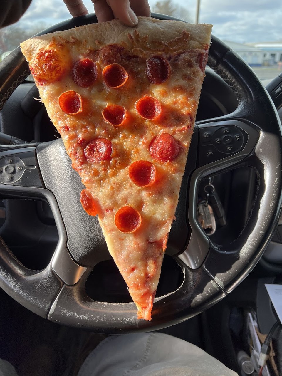 Pizza restaurant menu beside cold beverages
